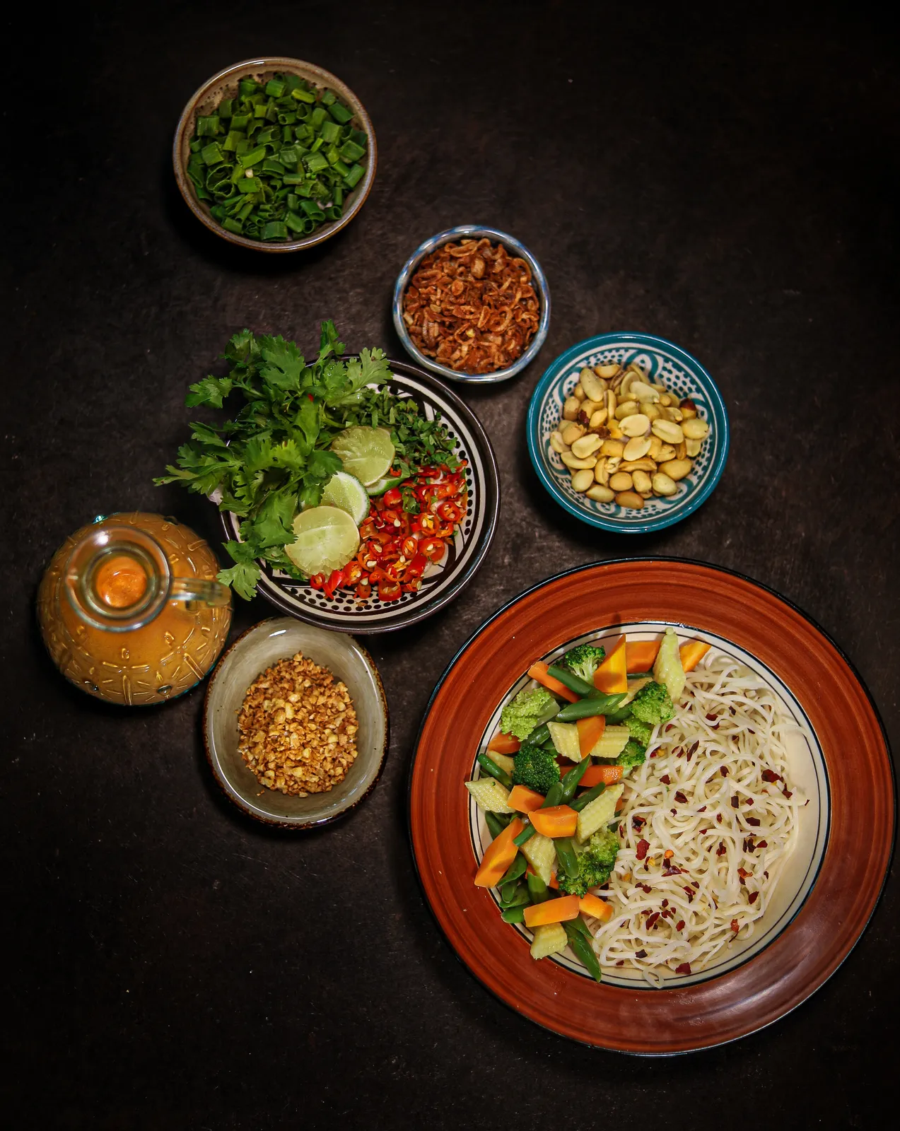 An overhead food composition with noodles and vegetables.